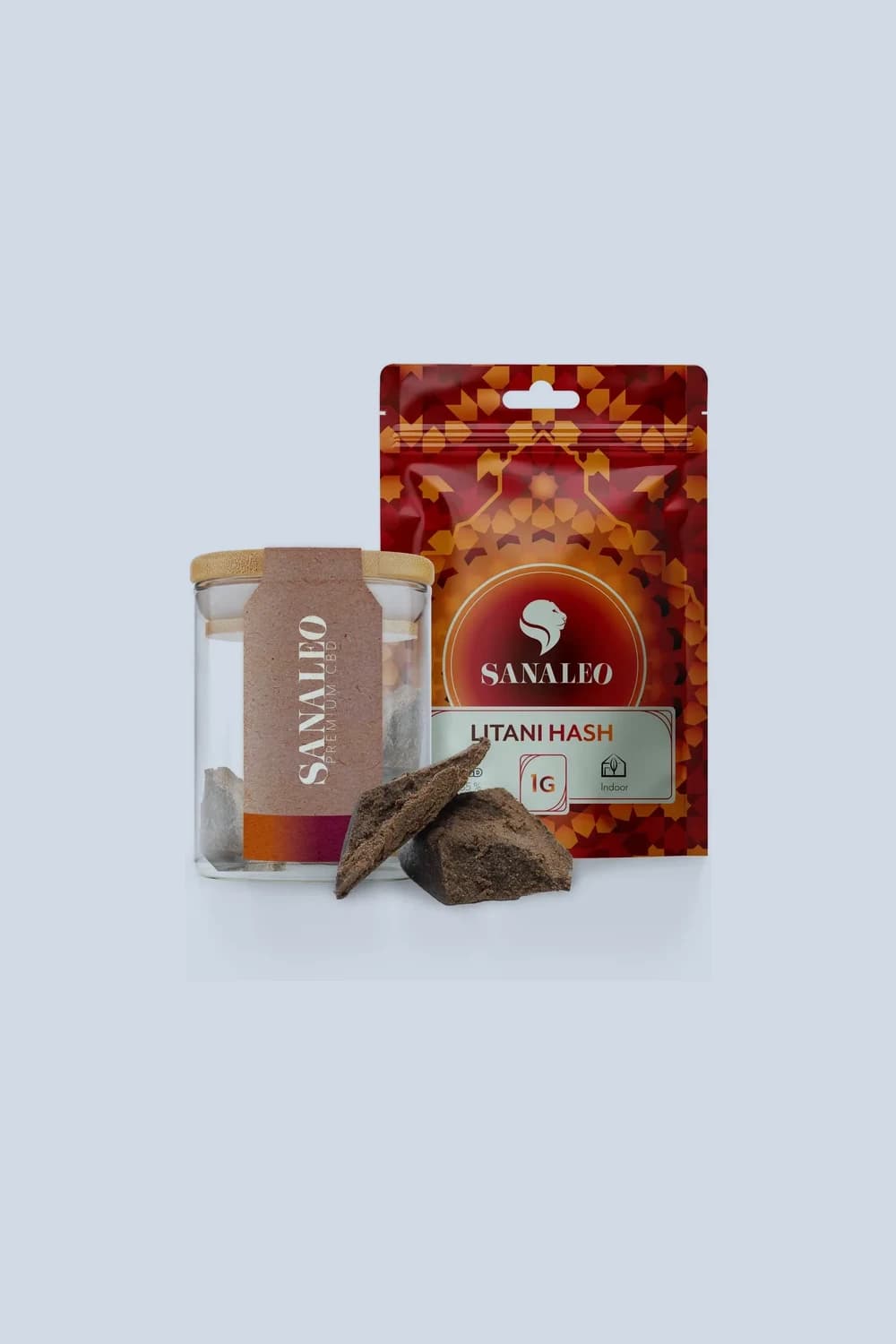Sanaleo Litani Hash: Glas mit Bambusdeckel und rote Standbodenverpackung, davor zwei dunkle Haschplatten.